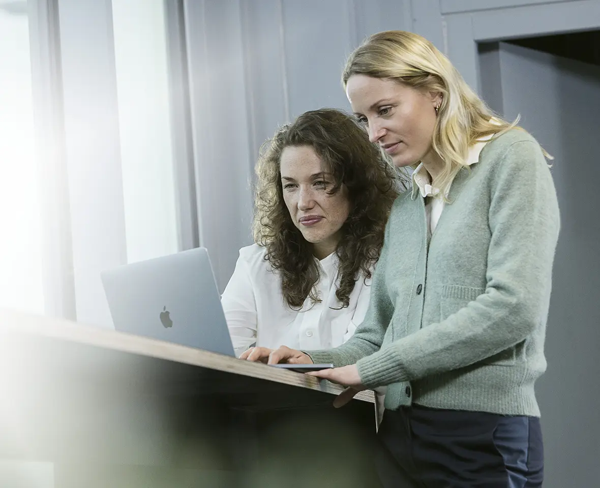 Apple MacBook Pro and two Female in enterprise environment